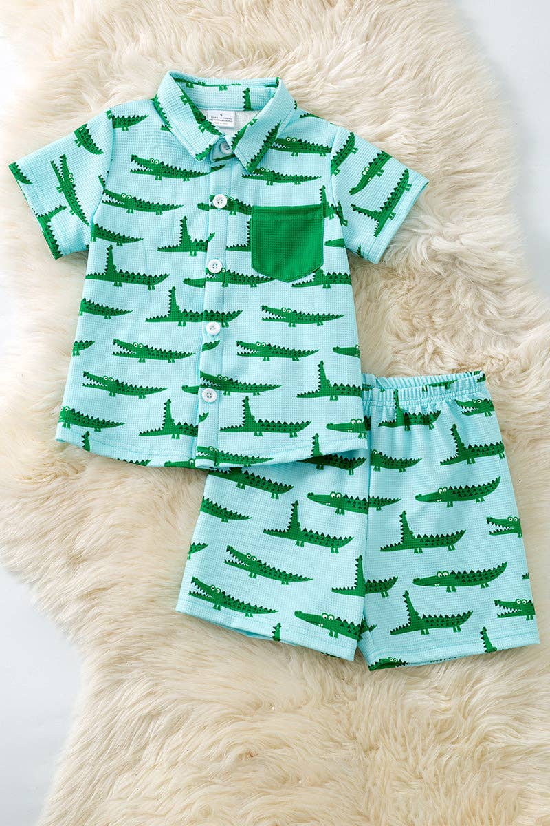 Cute crocodile printed on blue button up shirt and matching shorts.