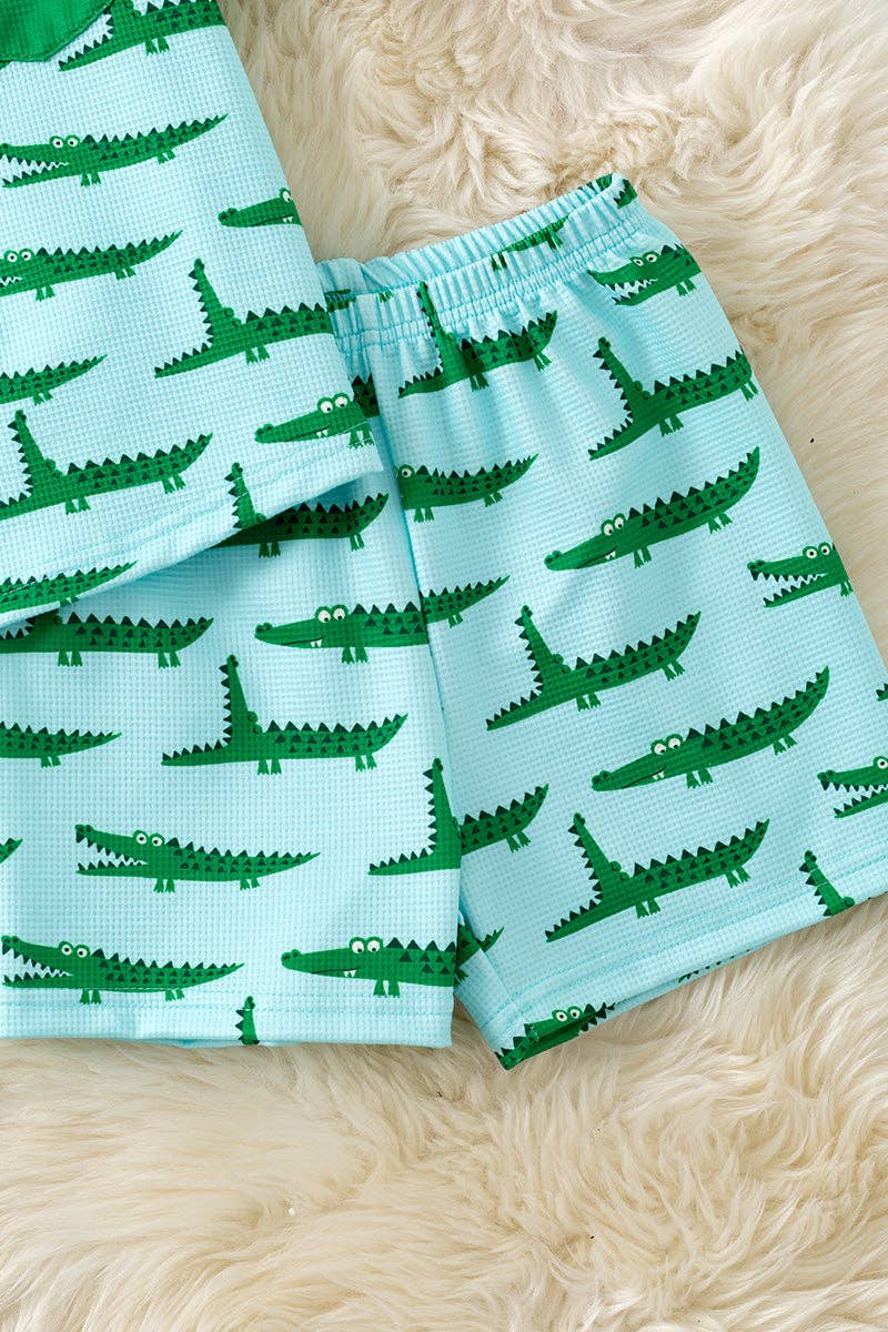 Cute crocodile printed on blue button up shirt and matching shorts.
